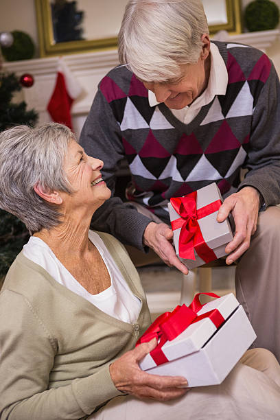 istock Senior couple sitting beside their christmas tree 529983023