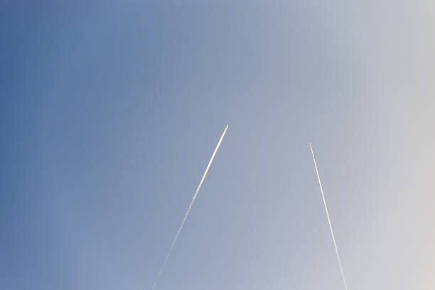 istock The plane flies low in the sky, leaving white trail 529984099