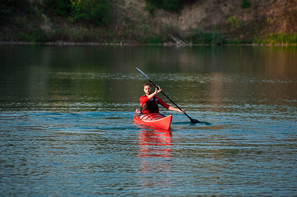 человек, каякинг на озере на закате - rowboat river lake nautical vessel стоковые фото и изображения