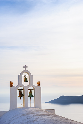 Orthodox church bell tower. Imegovigli village, Santorini Greece. Copyspace
