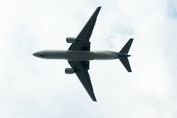 istock airplane flying in the blue sky with clouds 529985802