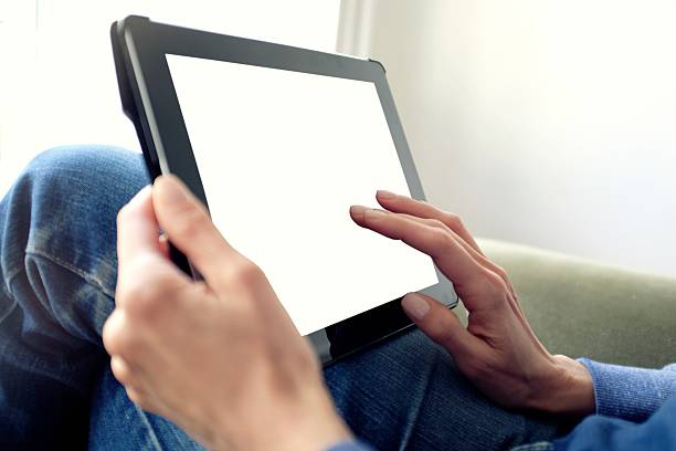 istock Woman holding digital tablet with blank screen 529986480