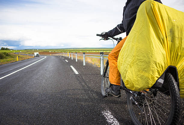 istock Biker rides on road at sunny summer day in Iceland 529986588