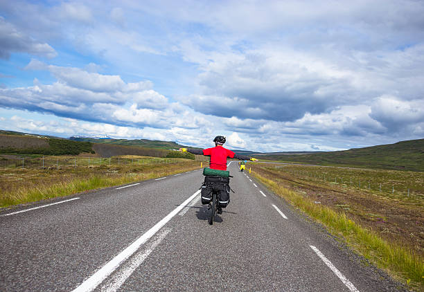 istock Biker rides on road at sunny summer day in Iceland 529986688