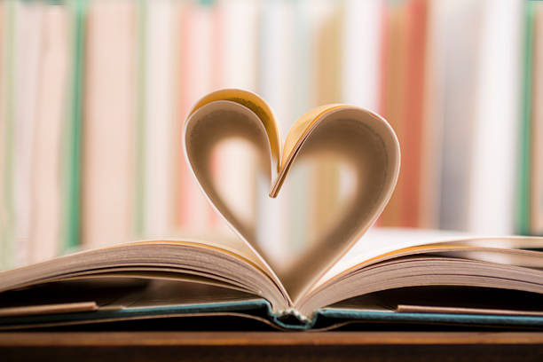 istock Love Reading!  Heart shape in open book pages. Education, school. 529987158