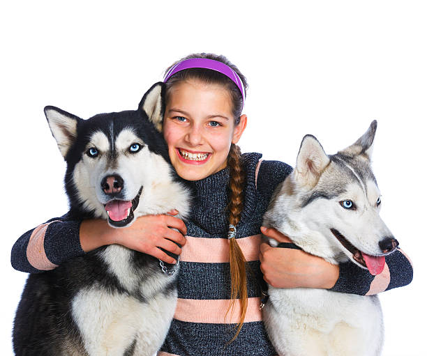 istock Girl is with her dogs husky 529988912