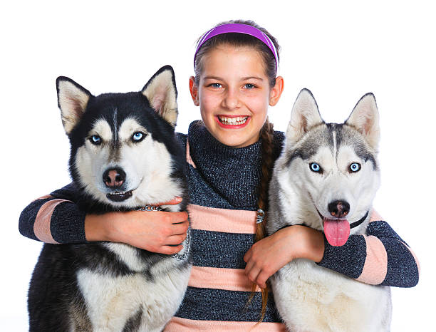 istock Girl is with her dogs husky 529988922