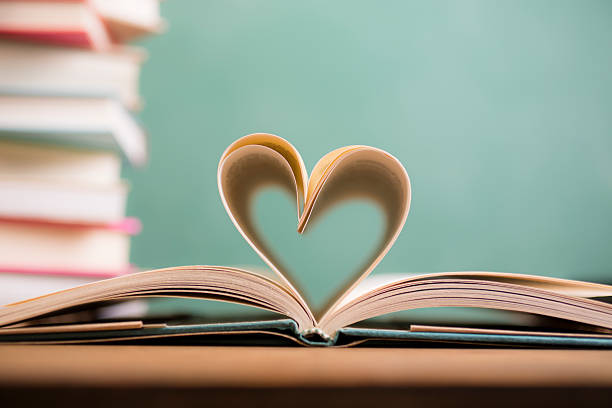 istock Love Reading!  Heart shape in open book pages. Education, school. 529992482