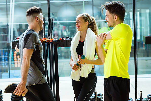 istock Group of sporty people talking after class in gym. 529992832