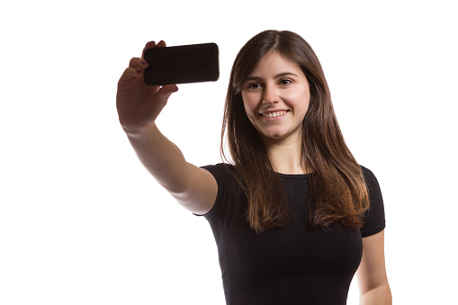 one beautiful teenager girl taking a selfie smiling portrait on white background