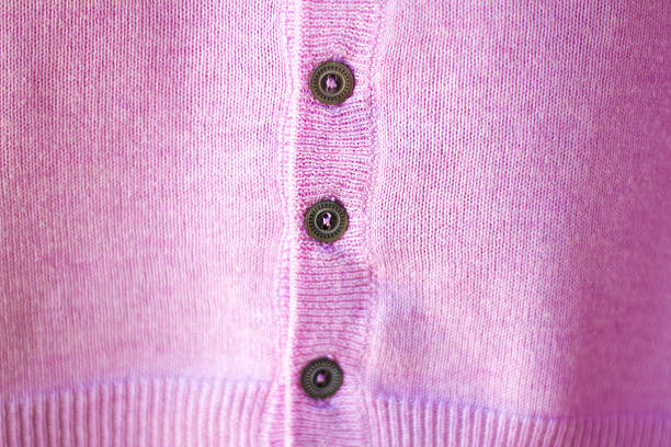 A pink cashmere sweater and old buttons (full frame and close up). Soft selective focus and copy space available.