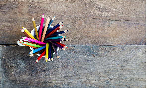istock Stack of colored pencils in a glass on wooden background 529995127