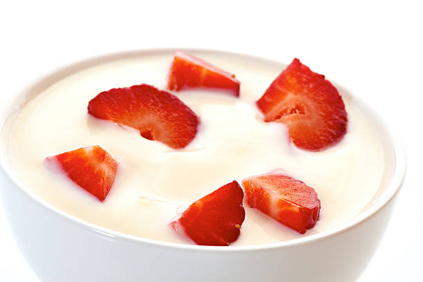 istock Yogurt with strawberries in bowl on white 529995840