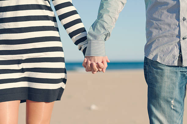 istock Closeup of couple holding hands 529996473