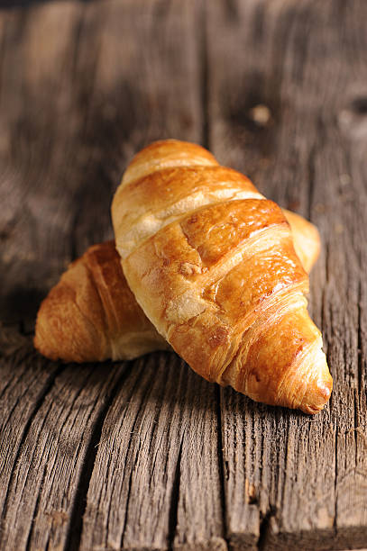 istock Fresh Croissants on wooden rustic background 529997077