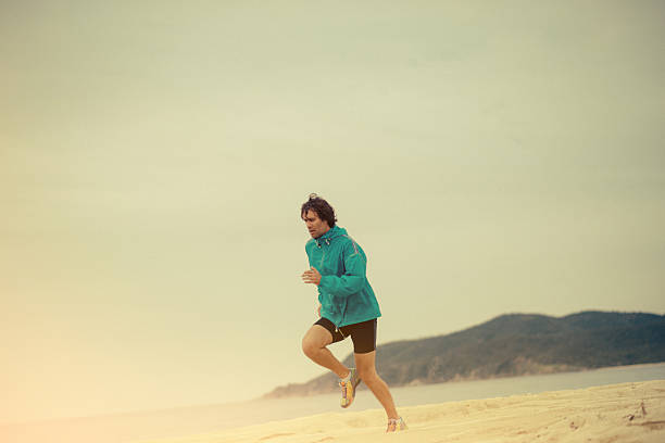 Young man relaxation jogging training at seaside on sandy beach. Image taken with Nikon D800 and professional Nikon lens, developed from RAW in XXXL size. Location: Sithonia, Greece, South Europe, Europe