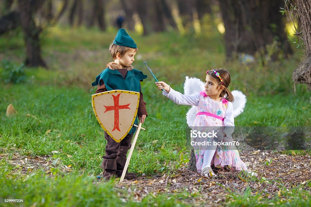 Fairy and Knight Cute little children dressed up as a fairy and a knight playing in a forest Child Stock Photo