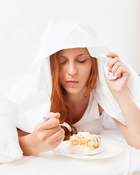 istock girl eating biscuit in her bed 529997269