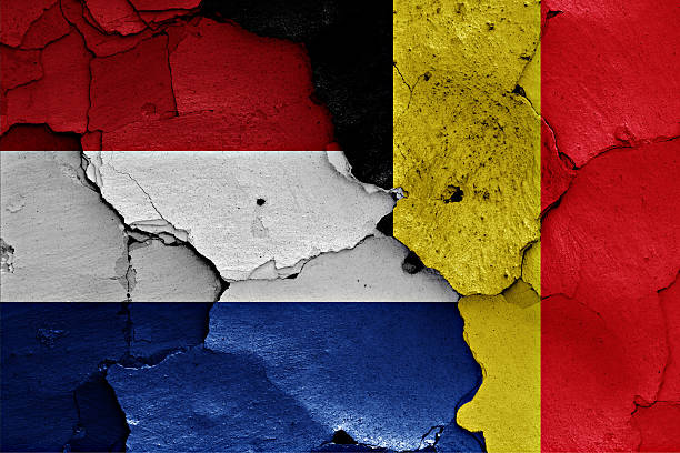 istock flags of Netherlands and Belgium painted on cracked wall 529997664