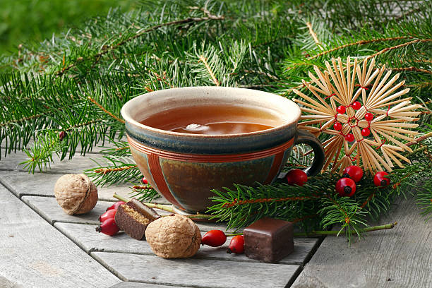 istock tea in a pottery cup with Christmas decoration and goodies, 529997701