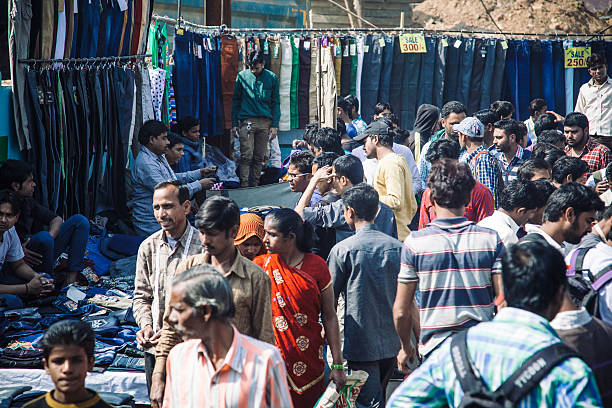 Old Delhi market Old Delhi street scene, in one of the city's markets, where Indian men can be seen walking around. Street vendors are selling different brands of clothing. old delhi stock pictures, royalty-free photos & images