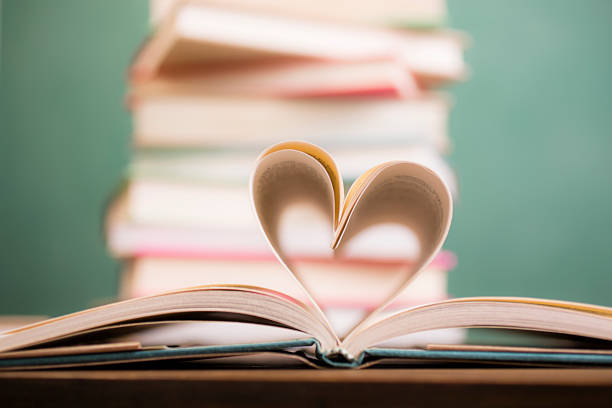 istock Love Reading!  Heart shape in open book pages. Education, school. 529997820