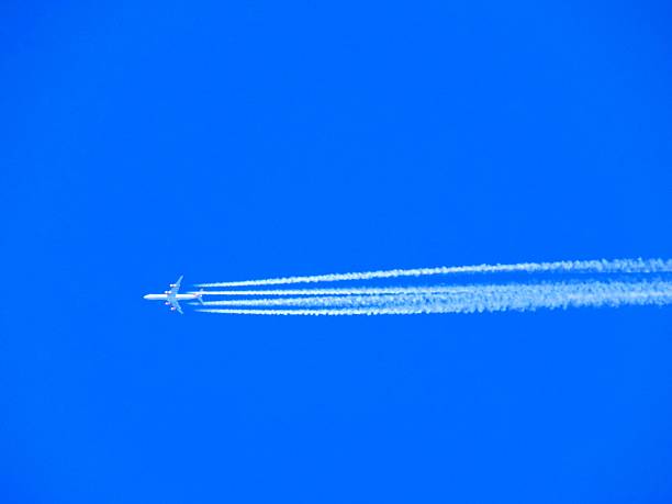 istock Airplane with chemtrails on blue sky 530000072