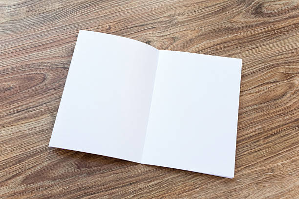istock Open blank brochure, magazine is on a wooden desk 530002870