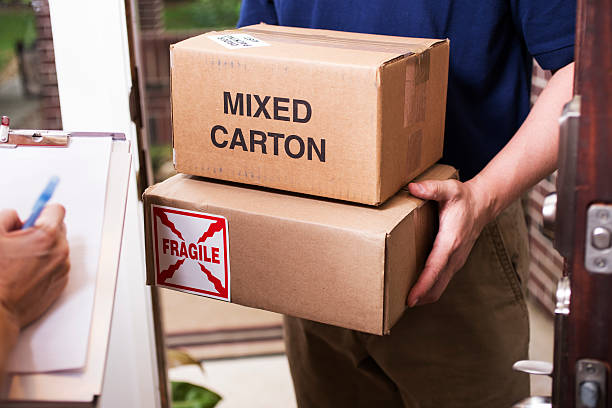 istock Man delivers packages to customer at home. 530004784