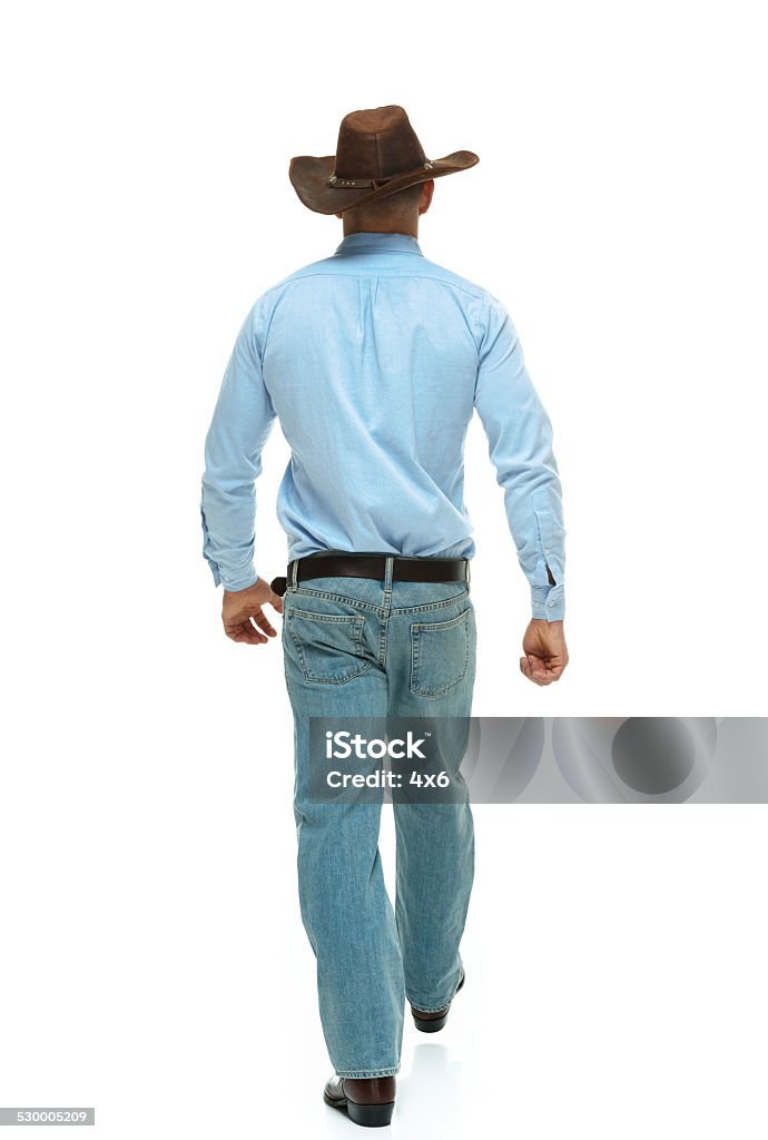 Rear view of cowboy waking Rear view of cowboy wakinghttp://www.twodozendesign.info/i/1.png Rear View Stock Photo