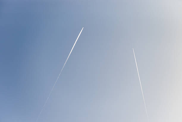 istock The plane flies low in the sky, leaving white trail 530005707