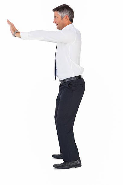 istock Side view of a businessman pushing 530005969