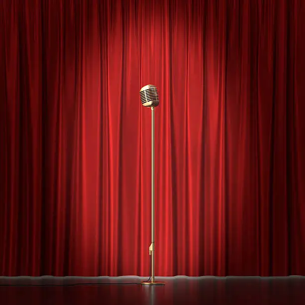 Retro gold microphone on red cloth background.