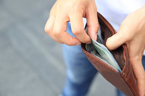 istock Hands taking  us dollars  out from wallet on the street 530006926