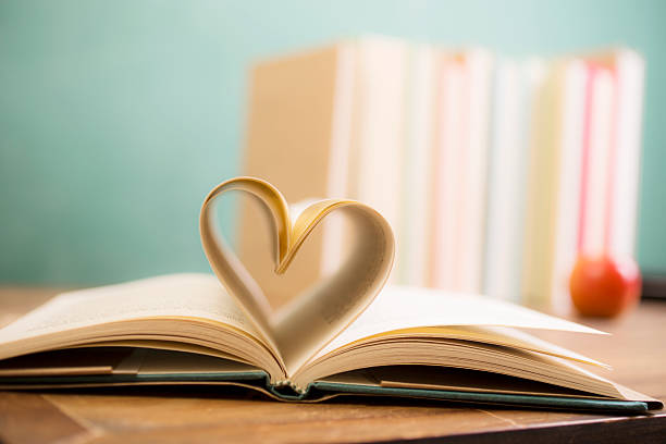 istock Love Reading!  Heart shape in open book pages. Education, school. 530007174