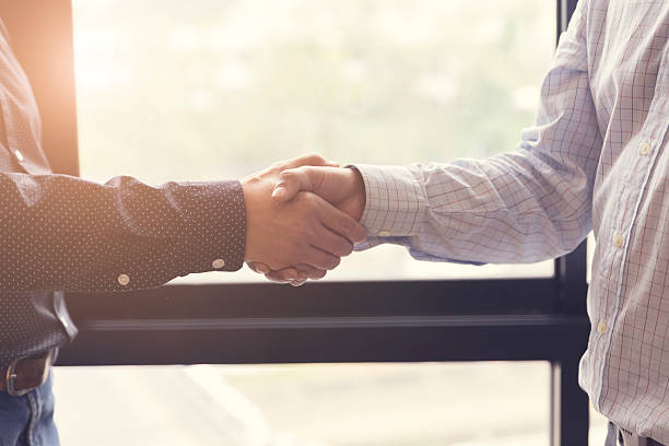 istock businessman handshaking for business acquisiton concept 530009502
