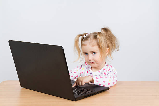 istock little girl at the computer. 530009856