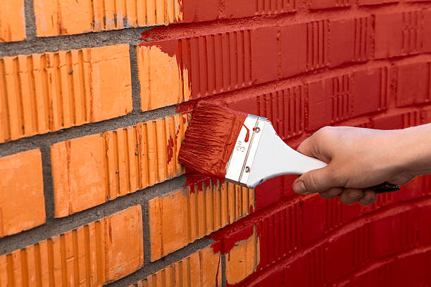 istock Human hand painting wall with red color 530009967