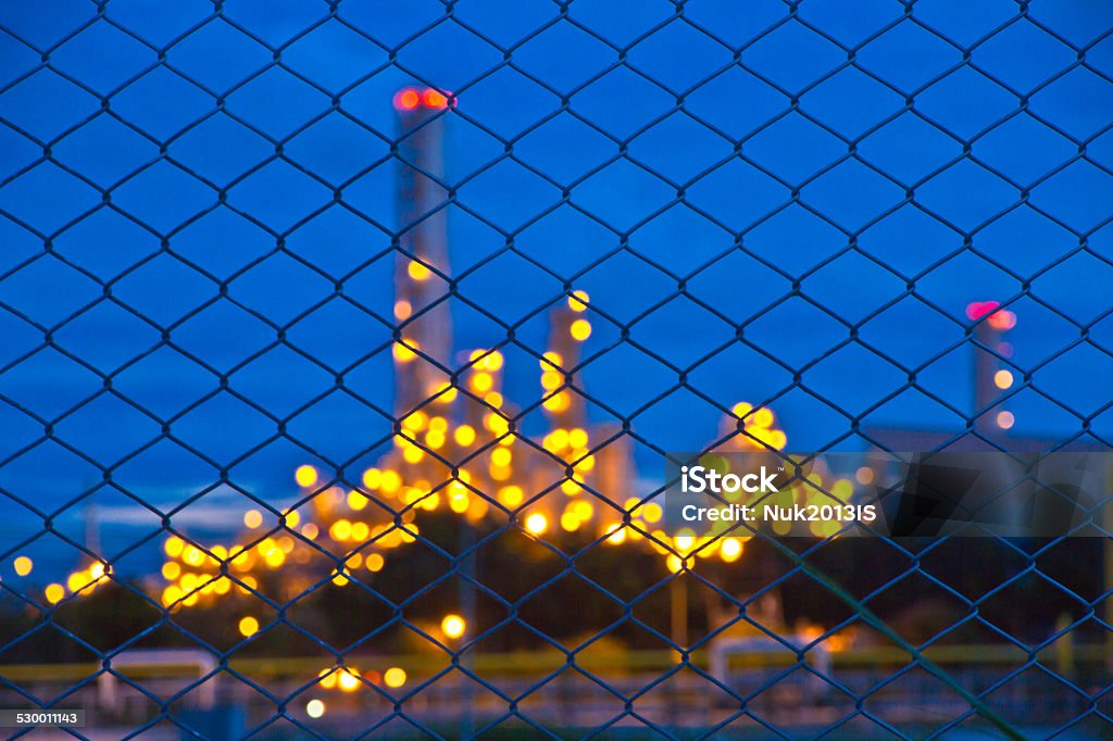 Defocused building and lights in plant in twilight time Chimney and building Architecture Stock Photo