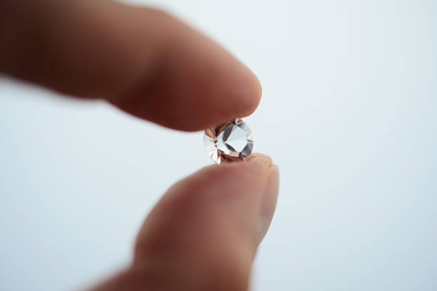 Hand holding a diamond close up stock photo