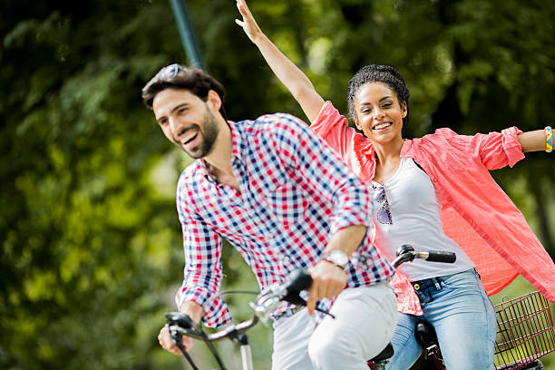 istock Young couple riding on the tandem bicycle 530011427