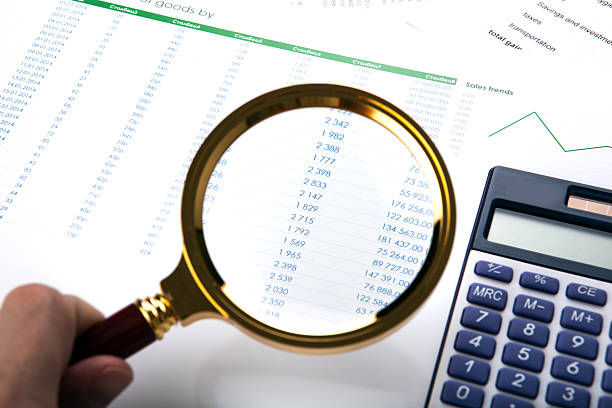 istock man considers the budget through a magnifying glass 530046023