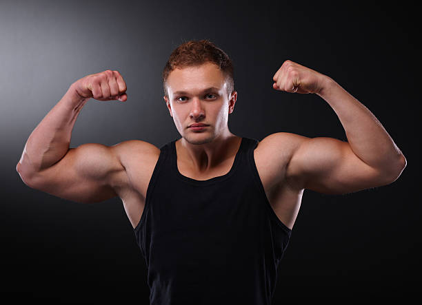 istock Healthy muscular young man. Isolated on black 530051165