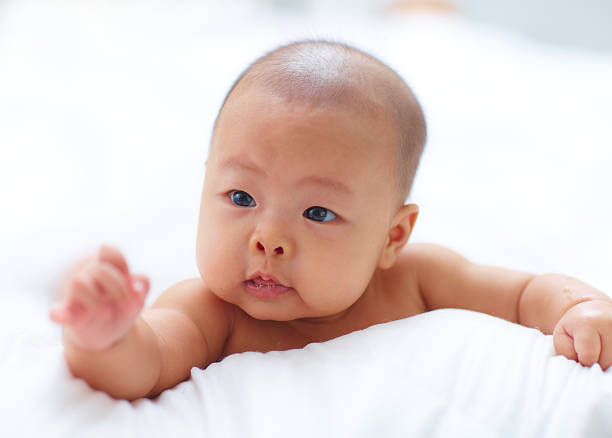 istock little baby girl in bed 530085471