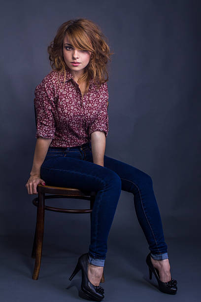 istock Attractive young woman sitting on a chair 530086183
