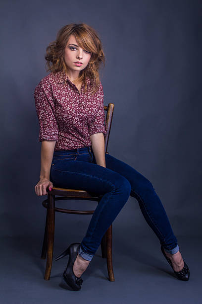 istock Attractive young woman sitting on a chair 530086185