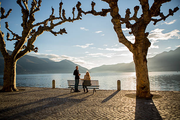 istock Silhouette people on bench near lake 530088643