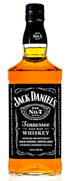 Huntly, United Kingdom - December 21, 2014: A 1 litre bottle of Jack Daniel's Tennessee whiskey isolated on white. Over 10 million cases of Old No.7, also called black label, is produced annually at the distillery in Lynchburg, Tennessee using corn, rye and malted barley. The distillery is a popular tourist attraction, drawing more than two hundred thousand visitors each year.
