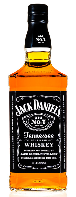 Huntly, United Kingdom - December 21, 2014: A 1 litre bottle of Jack Daniel's Tennessee whiskey isolated on white. Over 10 million cases of Old No.7, also called black label, is produced annually at the distillery in Lynchburg, Tennessee using corn, rye and malted barley. The distillery is a popular tourist attraction, drawing more than two hundred thousand visitors each year.