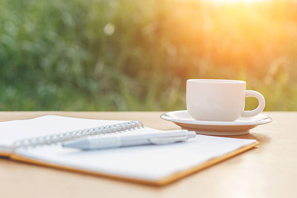 istock cup of coffee on the table and notebook 530089259